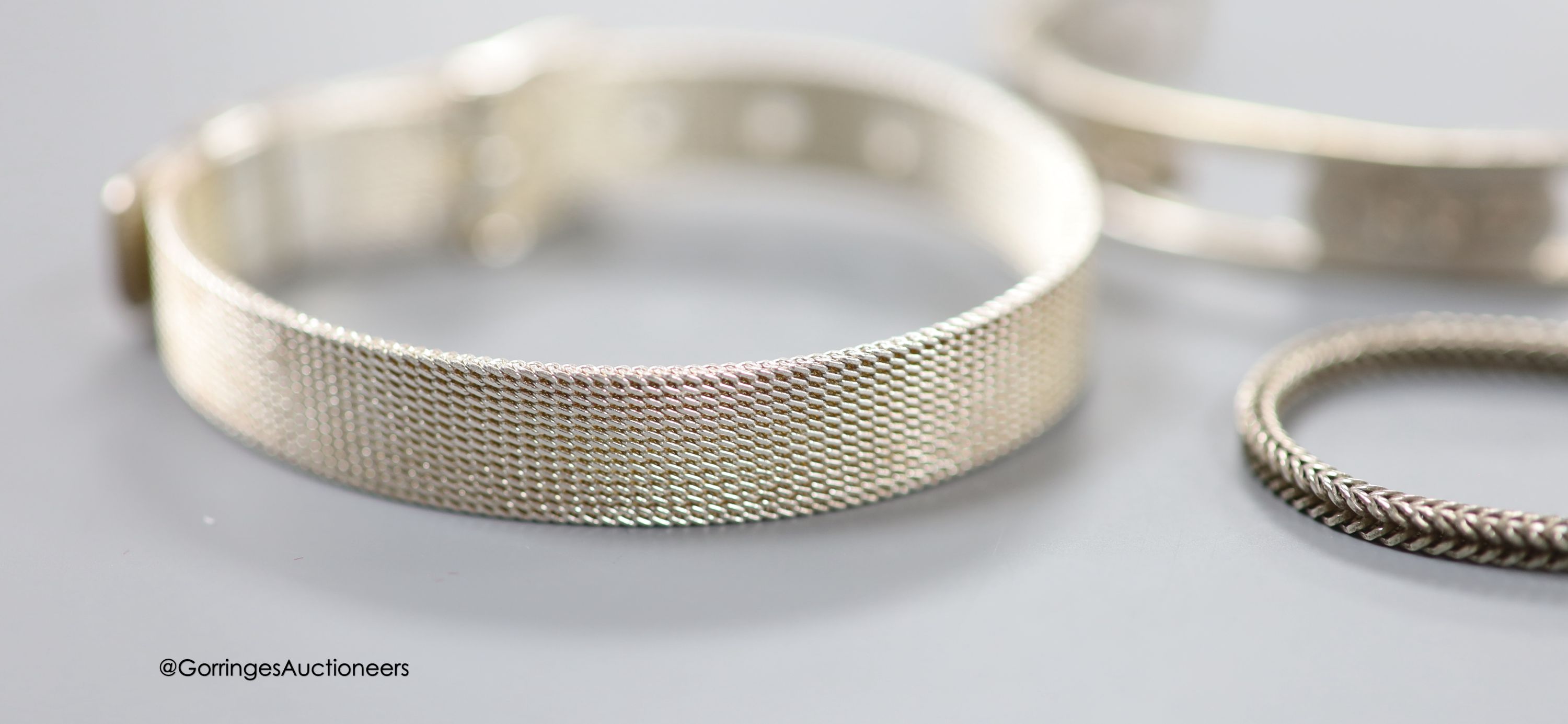 A modern 925 'buckle' bracelet and three other bracelets.